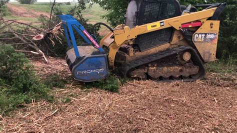 photo of skid steer excavator removed a downed tree rootball|skid steer mulcher.